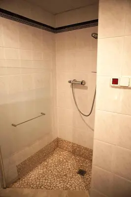 a bathroom with a shower with a tiled floor at Apartamento playa Las Arenas in Valencia