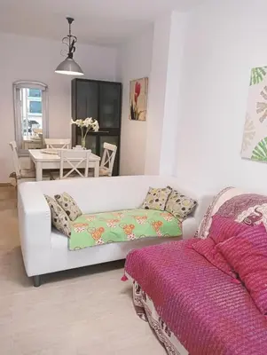 a living room with a white couch and a table at Apartamentos Playa de Moncofa in Moncófar