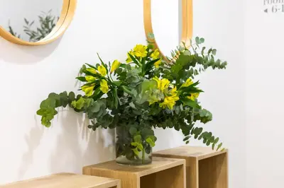 a vase filled with yellow flowers sitting on wooden shelves at Pensión Alicante by Moontels in Valencia