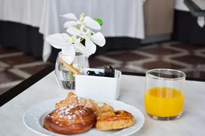 a plate of pastries and a glass of orange juice at Hotel Vila-real Palace in Villareal