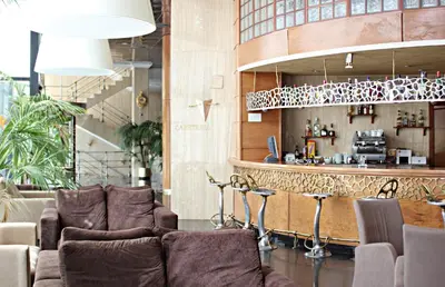 a bar in a restaurant with chairs and a counter at Hotel Vila-real Palace in Villareal