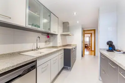 a kitchen with white cabinets and a sink at Apartamento en Av. de Francia y C.Artes y Ciencias in Valencia