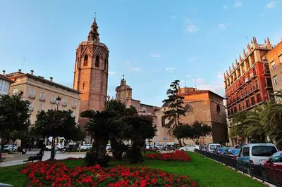 a large building with a clock tower in a city at Apartamento en Av. de Francia y C.Artes y Ciencias in Valencia