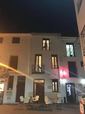 a building with chairs and a table in front of it at Casa La Abuela in Chulilla