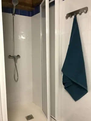 a bathroom with a shower with a green towel at Casa La Abuela in Chulilla