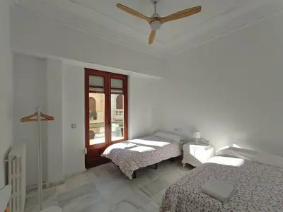 a bedroom with two beds and a ceiling fan at Entre la Estación y el Ayuntamiento in Valencia