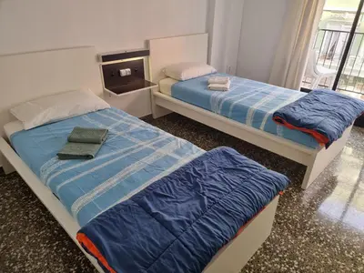 two beds in a small room with at Apartamento Ruzafa in Valencia