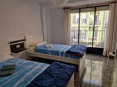 a hotel room with two beds and a window at Apartamento Ruzafa in Valencia
