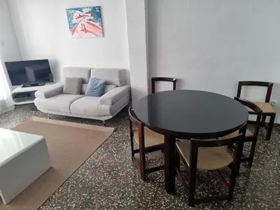 a living room with a table and a couch at Apartamento Ruzafa in Valencia
