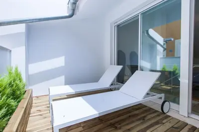 a white bench on a balcony with a window at City Center Atico 360 in Valencia