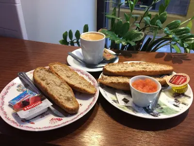 a table with two plates of toast and a cup of coffee at City Center Atico 360 in Valencia