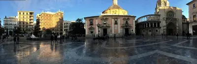 a building with a clock tower on a city street at City Center Atico 360 in Valencia