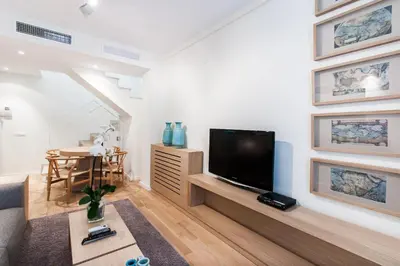 a living room with a flat screen tv on a wall at City Center Atico 360 in Valencia
