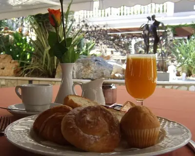 a plate of pastries and a glass of orange juice at Casa Quiquet in Beniparrell