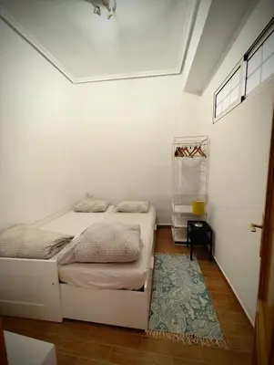 a living room with a bed and a chair at City of Arts in Valencia