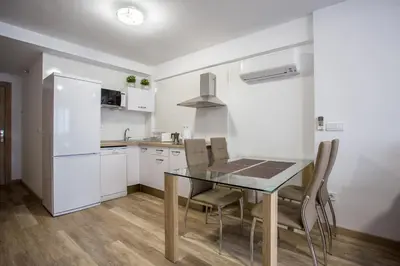 a kitchen with a table and chairs in a room at Versus Apartments near City of Arts 2 in Valencia
