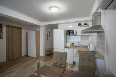 a kitchen with white cabinets and a glass table at Versus Apartments near City of Arts 2 in Valencia
