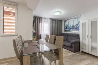 a dining room with a table and chairs and a couch at Versus Apartments near City of Arts 2 in Valencia
