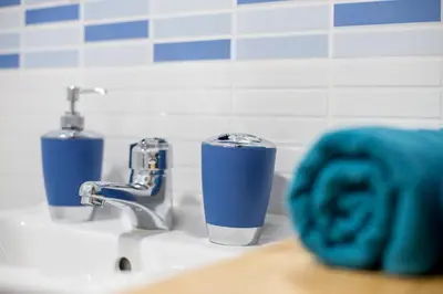 a cup sitting on a sink next to two faucets at Versus Apartments near City of Arts 2 in Valencia
