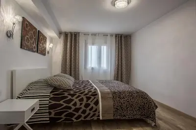 a bedroom with a zebra print bed and a window at Versus Apartments near City of Arts 2 in Valencia