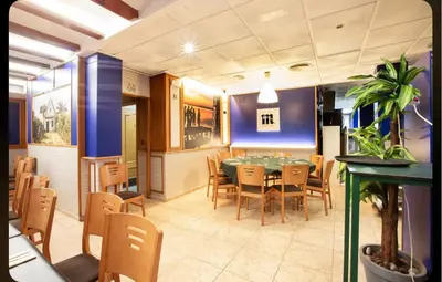 a dining room with a table and chairs at Hostal Andrés in El Saler