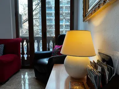 a living room with a red couch and a tv at Russafa Codrut in Valencia