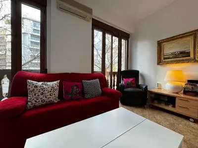 a living room with a red couch and a tv at Russafa Codrut in Valencia