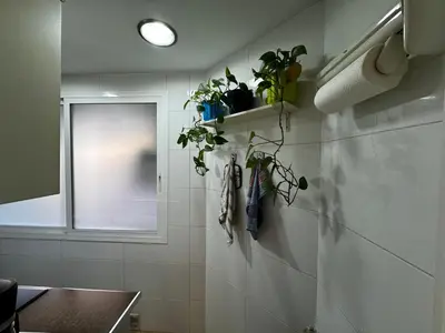 a small kitchen with a stove and a microwave at Russafa Codrut in Valencia