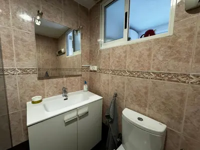a small bedroom with a bed and a dresser and a dresser at Russafa Codrut in Valencia