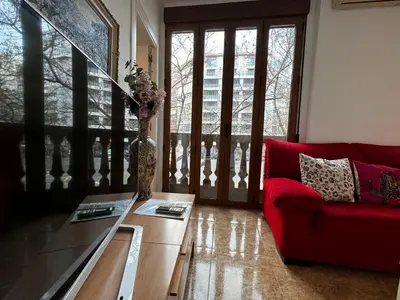 a living room with a red couch and a table at Russafa Codrut in Valencia