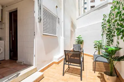 a balcony with two chairs and plants in a building at Exclusive Museum in Valencia
