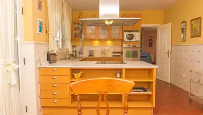 a kitchen with a sink and a chair in it at Casa Torre del Virrey in La Eliana