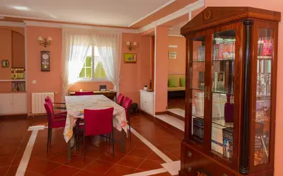 a dining room with a table and red chairs at Casa Torre del Virrey in La Eliana