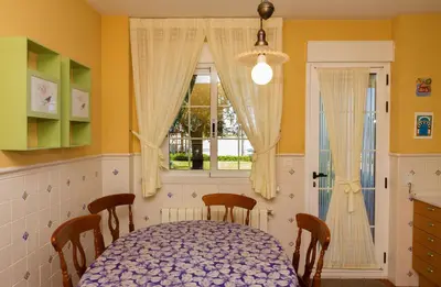 a dining room with a table and a window at Casa Torre del Virrey in La Eliana
