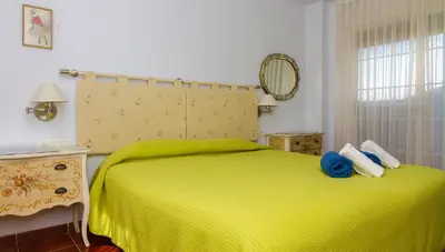 a bedroom with a green bed and a window at Casa Torre del Virrey in La Eliana