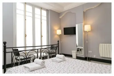 a bedroom with a bed with two white towels on it at Hi Valencia Canovas in Valencia