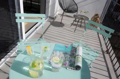a blue table on a porch with drinks on it at SingularStays Parque Central in Valencia