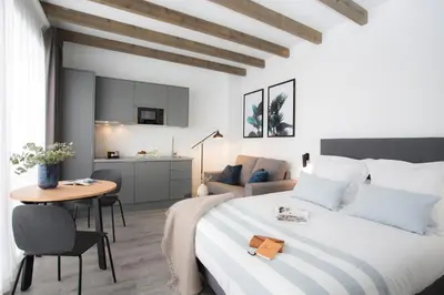 a bedroom with a large bed and a table at SingularStays Parque Central in Valencia