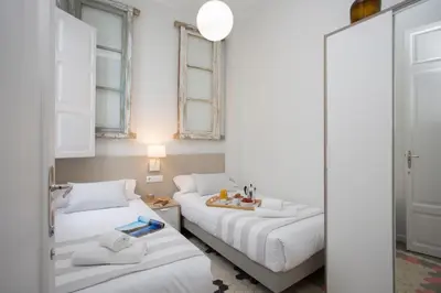 a room with two beds and a mirror at SingularStays Parque Central in Valencia