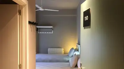 a small room with a bed and a ceiling fan at MD Modern Hotel - Jardines in Valencia