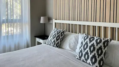 a bedroom with a bed with two pillows and a window at MD Modern Hotel - Jardines in Valencia