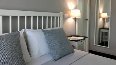 a bedroom with a bed with two pillows and a mirror at MD Modern Hotel - Jardines in Valencia