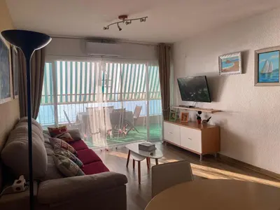 a living room with a couch and a tv at Apt. New Holiday Valencia Beach in El Puig