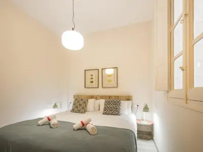 a bedroom with a bed with two pillows on it at Macflats Ayuntamiento in Valencia