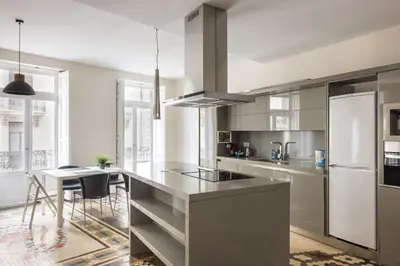 a kitchen with a white refrigerator and a table at Macflats Ayuntamiento in Valencia