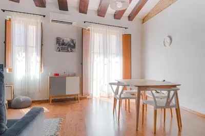 a living room with a wooden table and chairs at Invalencia - Baja Flat in Valencia
