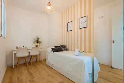 a bedroom with a bed and a table and chairs at Ayuntamiento Panoramic in Valencia
