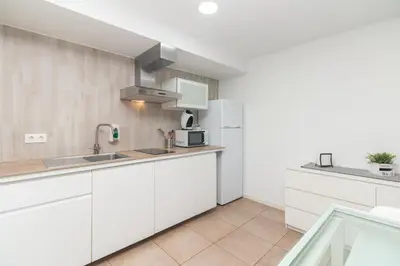 a kitchen with white cabinets and a sink at BET Apartments - Abastos in Valencia