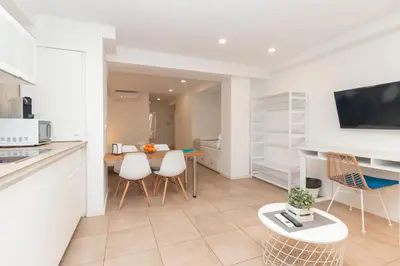 a kitchen and living room with a table and chairs at BET Apartments - Abastos in Valencia