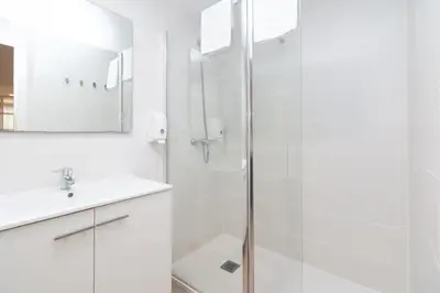 a white bathroom with a shower and a sink at BET Apartments - Abastos in Valencia
